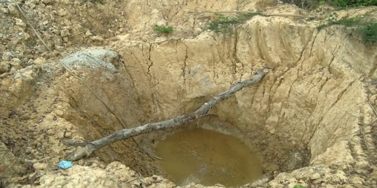 Woman galamsey pit