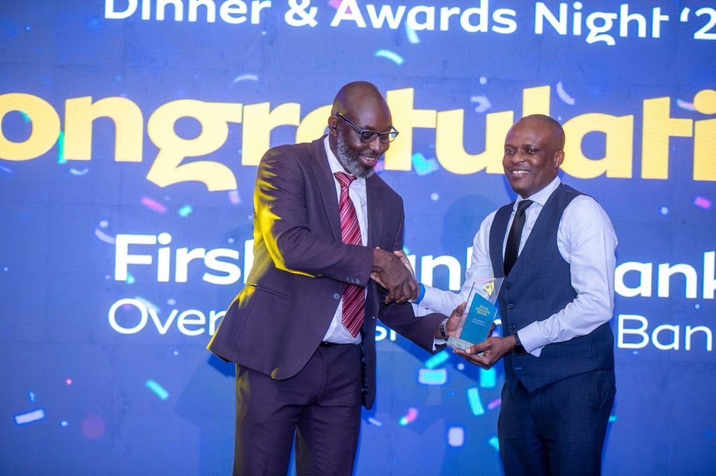 A representative from First Atlantic Bank receives the Overall Best Bank Partner award from Guido Sopiimeh, General Manager, Commercial Planning and Analytics, Pricing & Insights at MTN Ghana.